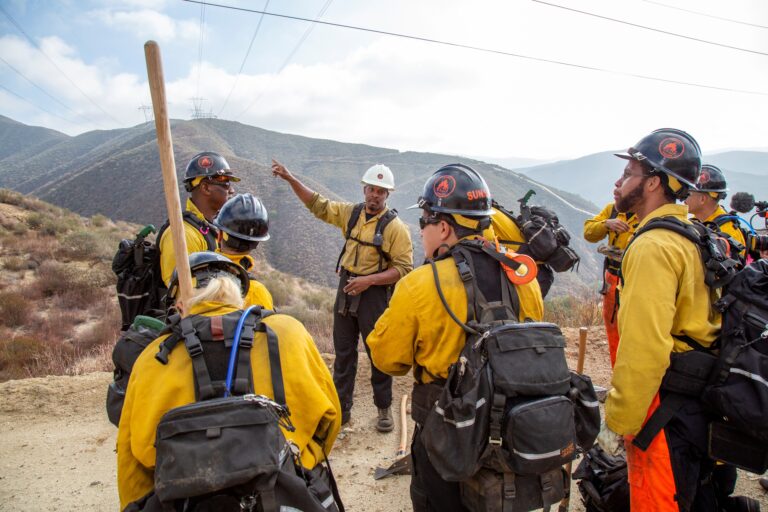 Chef trainee at employment social enterprise Kitchens for Good holds out a bowl of fresh food